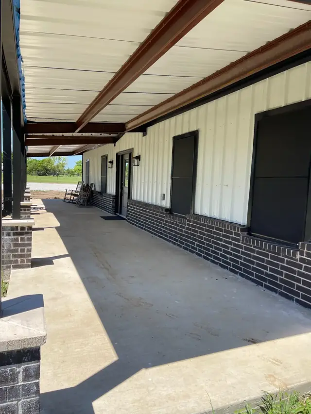 Covered porch with brick wainscot and stained beams