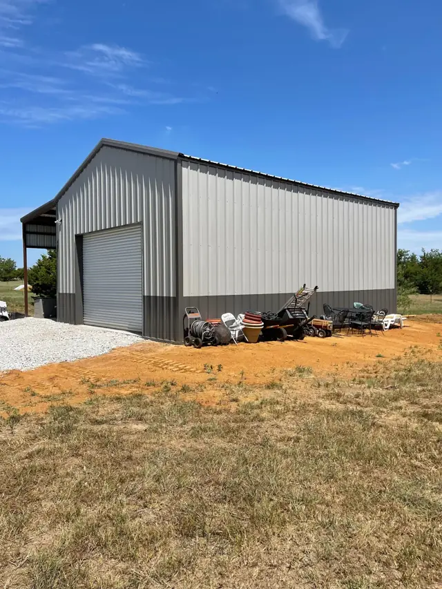 Metal shop building with a roll-up door