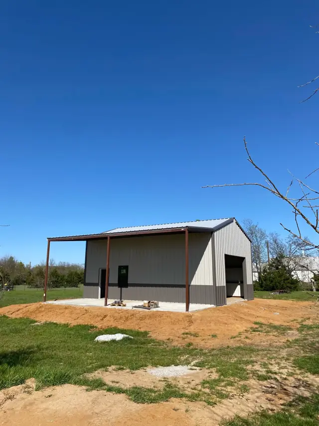 Metal building with a lean-to on a new pad