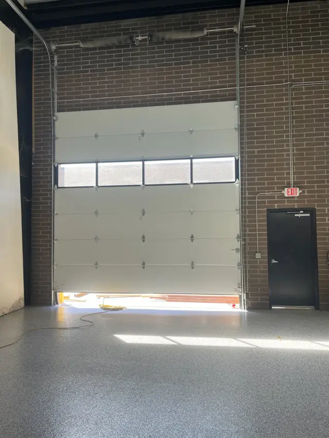 Unit with an overhead door and brick wall