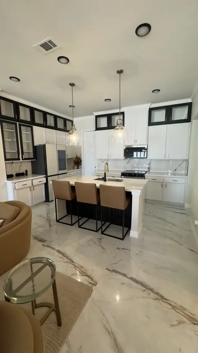 Open kitchen and dining area with marble-look floors