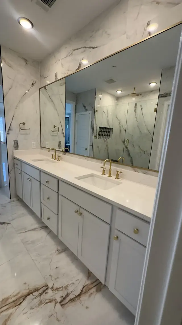 Marble-look vanity wall with a large mirror