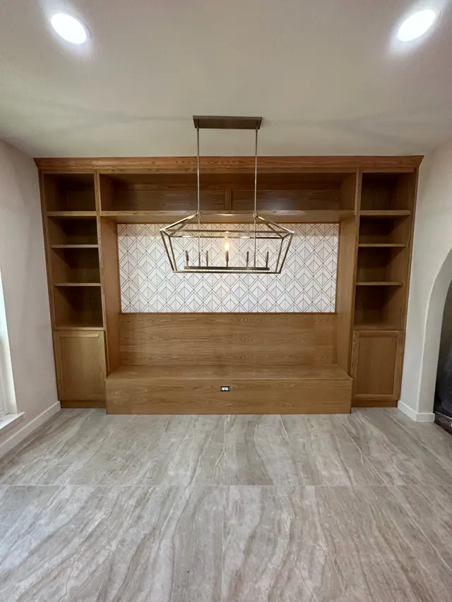 White-oak built-in bench and shelving with a lantern chandelier